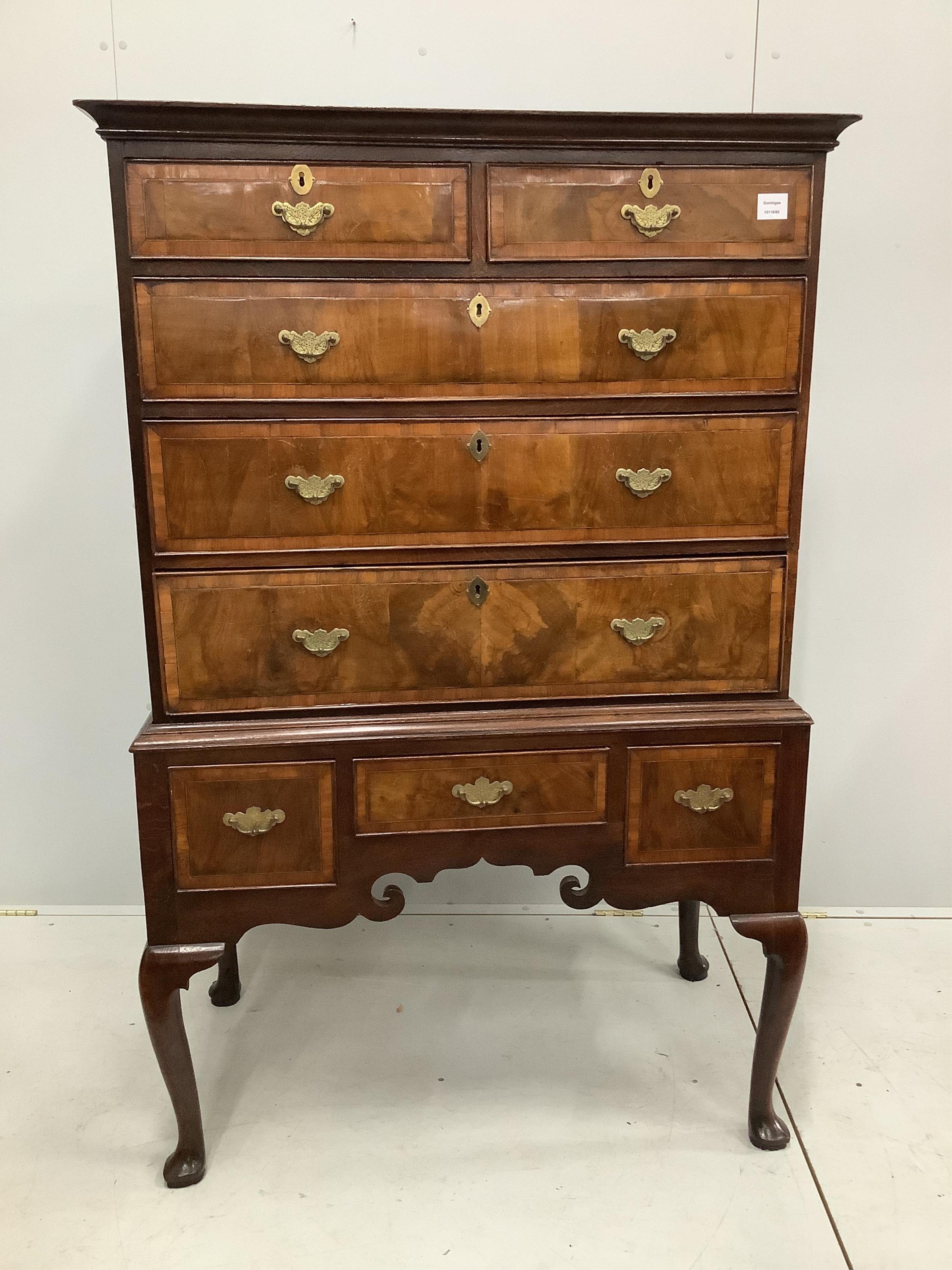 An 18th century banded walnut chest on stand, width 97cm, depth 53cm, height 152cm. Condition - fair